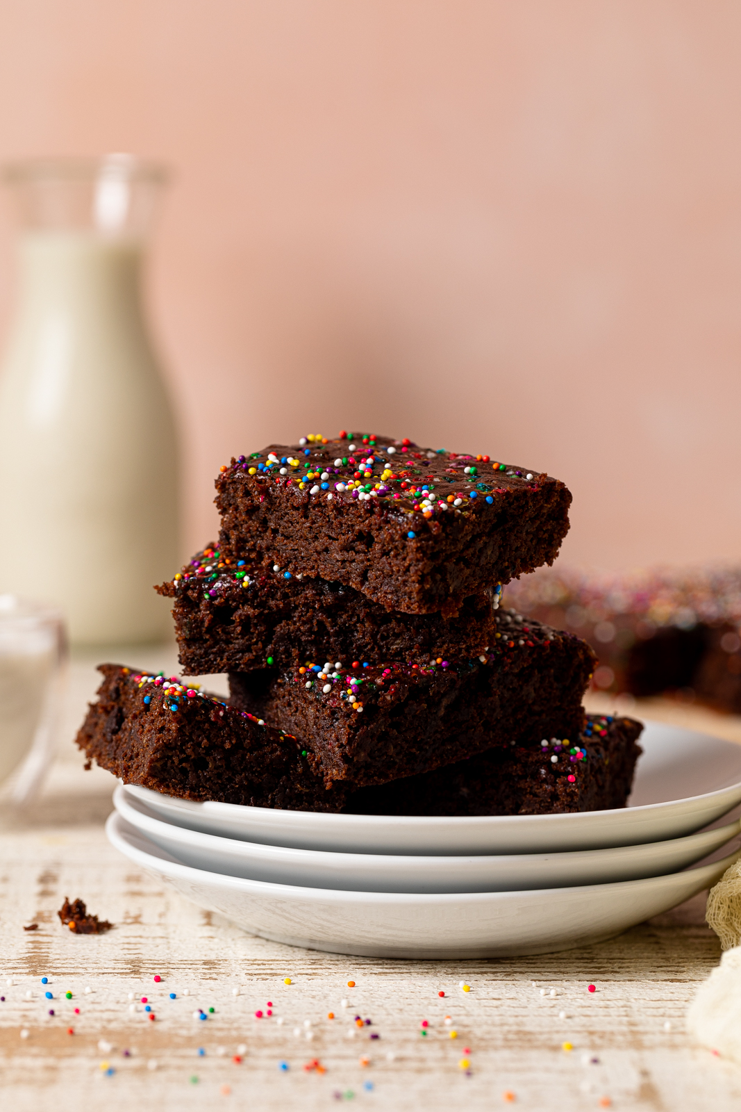 Pile of Vegan Zucchini Brownies on three stacked plates