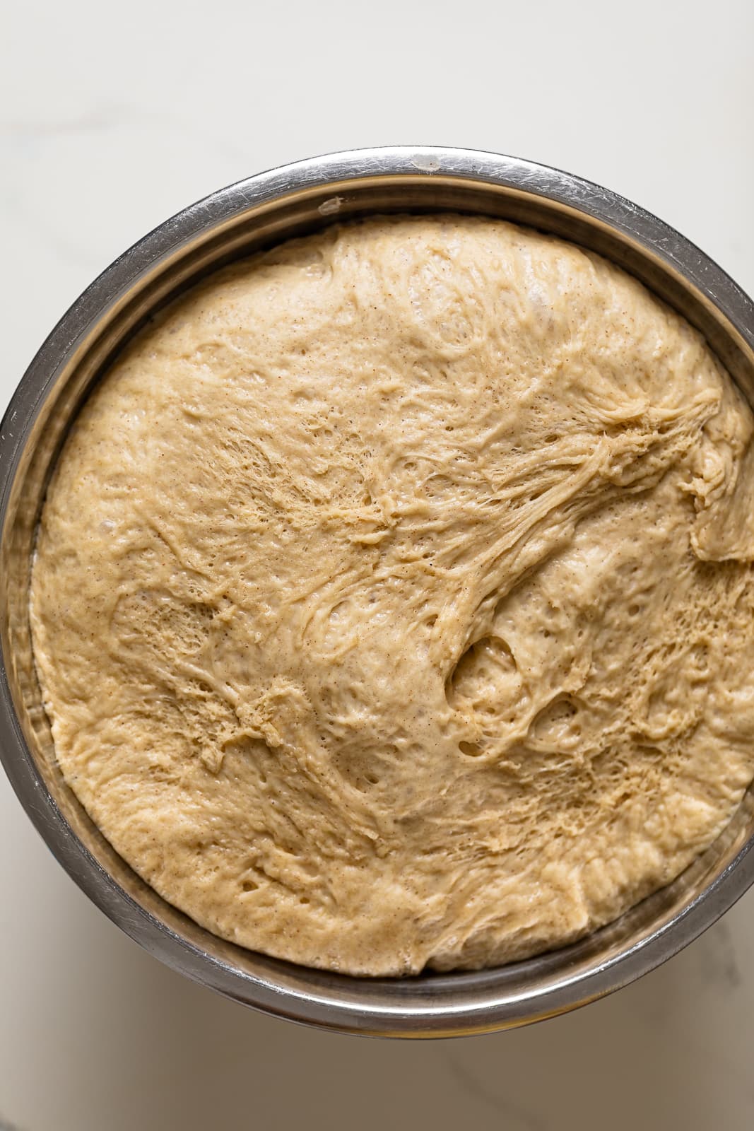Bowl of risen Vegan Apple Cinnamon Pull-Apart Bread dough