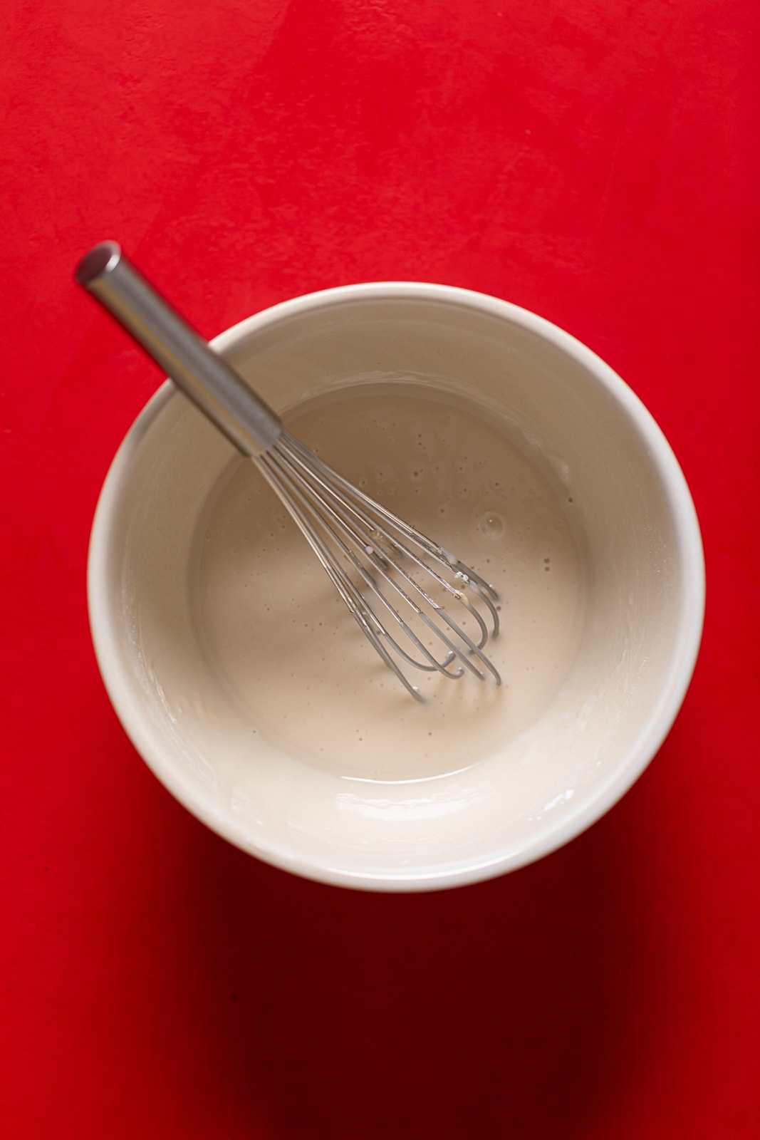 Whisk in a bowl of vanilla glaze