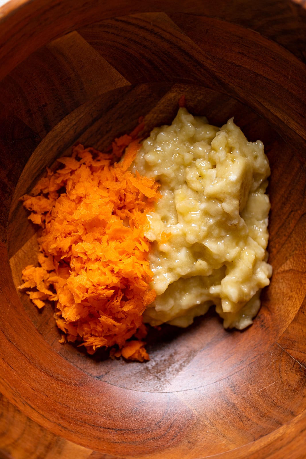 Bowl of shredded carrots and mashed bananas