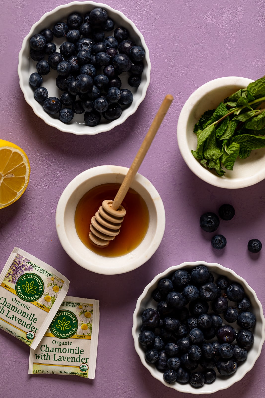 Ingredients for Blueberry Lavender Chamomile Mocktails including honey, chamomile tea with lavender, and lemon