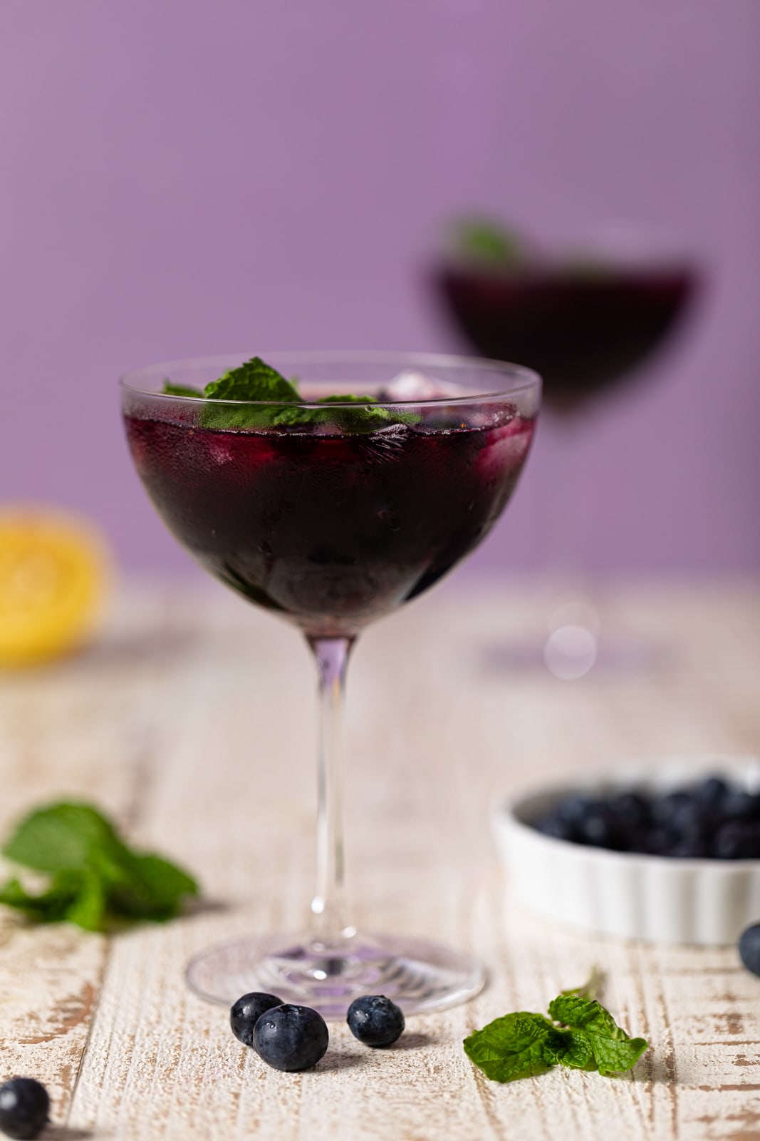 Blueberry Lavender Chamomile Mocktail in a long-stemmed glass