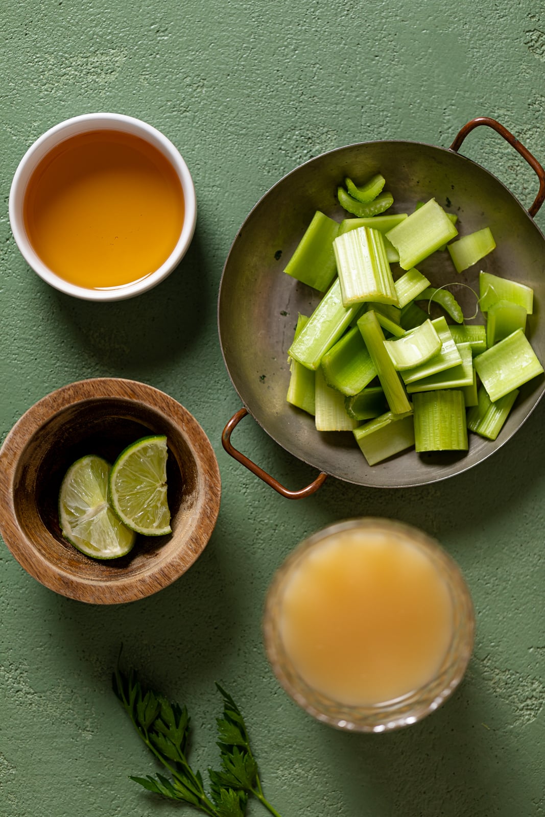 Ingredients for Celery Pineapple Detox Mocktail including lime, celery, and pineapple juice