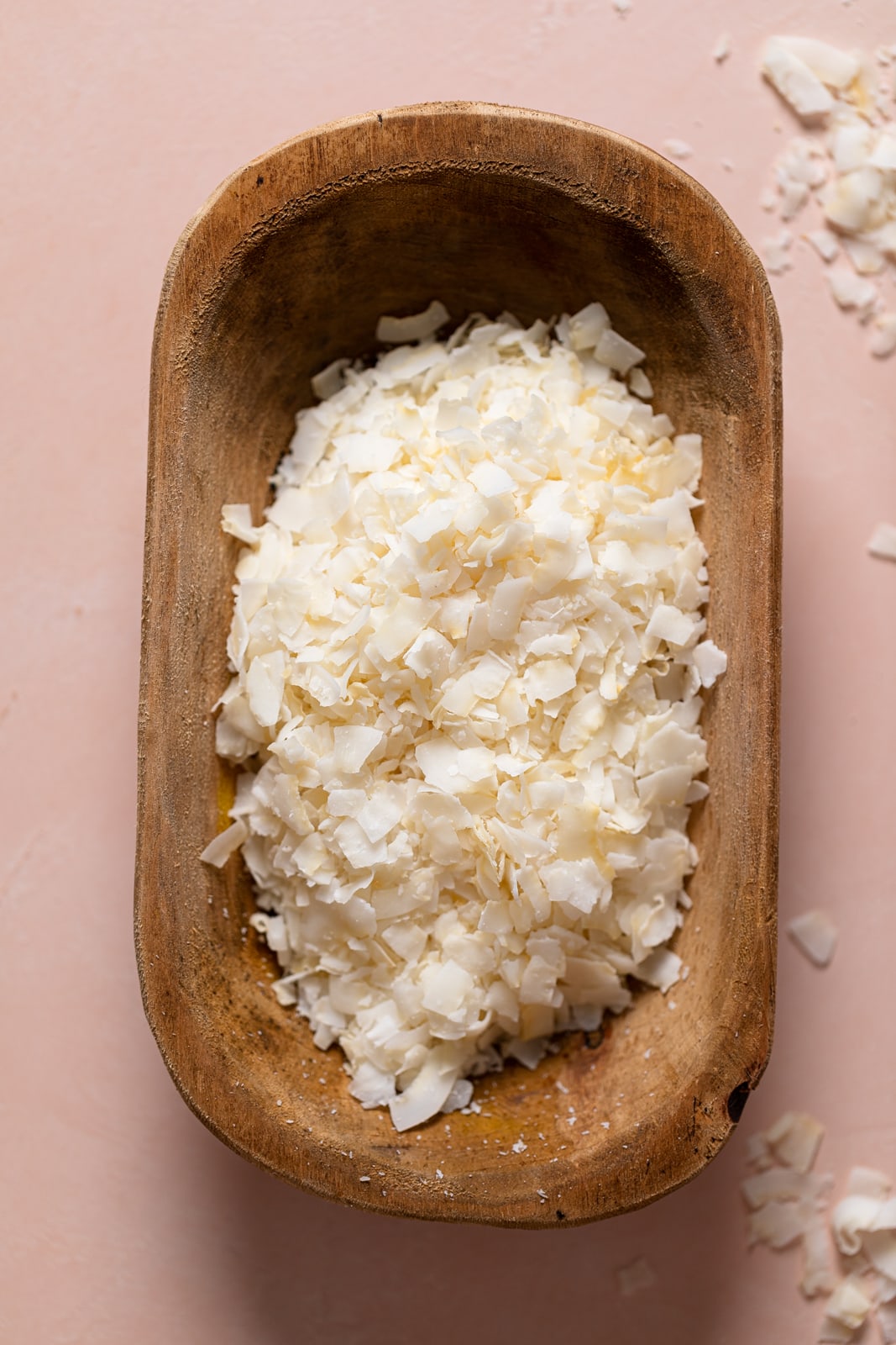 Wooden bowl of shredded coconut