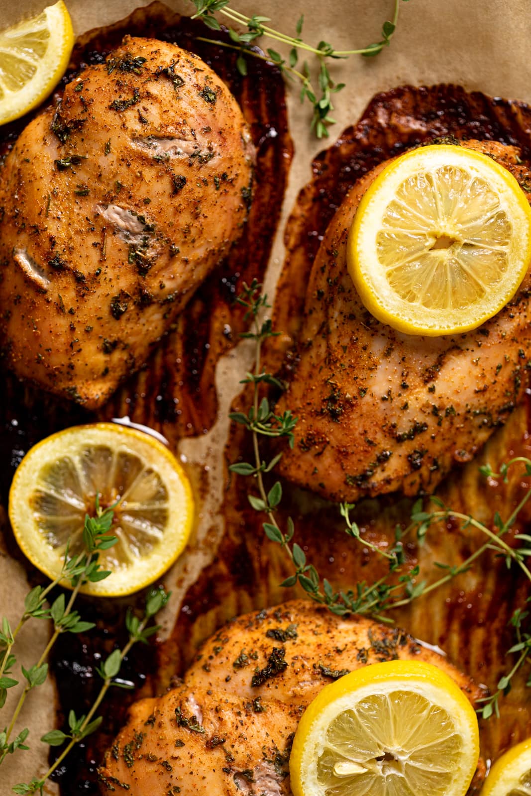 Closeup of Creamy Lemon Herb Roasted Chicken on parchment paper