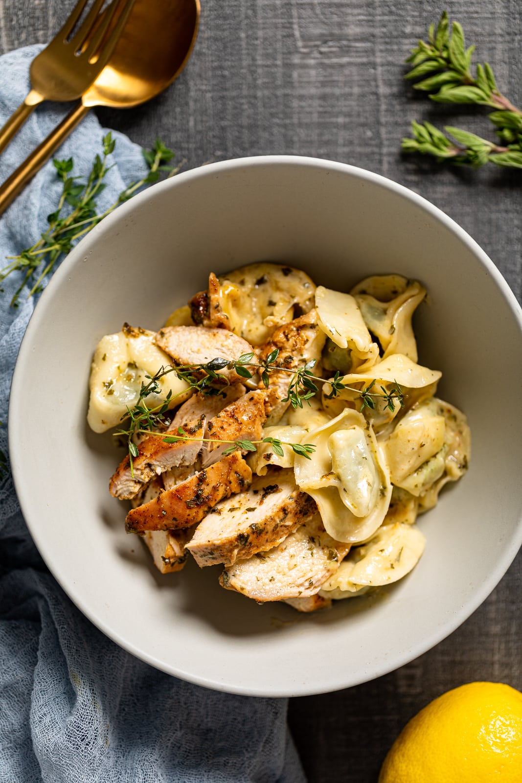 Bowl of Creamy Lemon Herb Roasted Chicken with Spinach Tortellini 