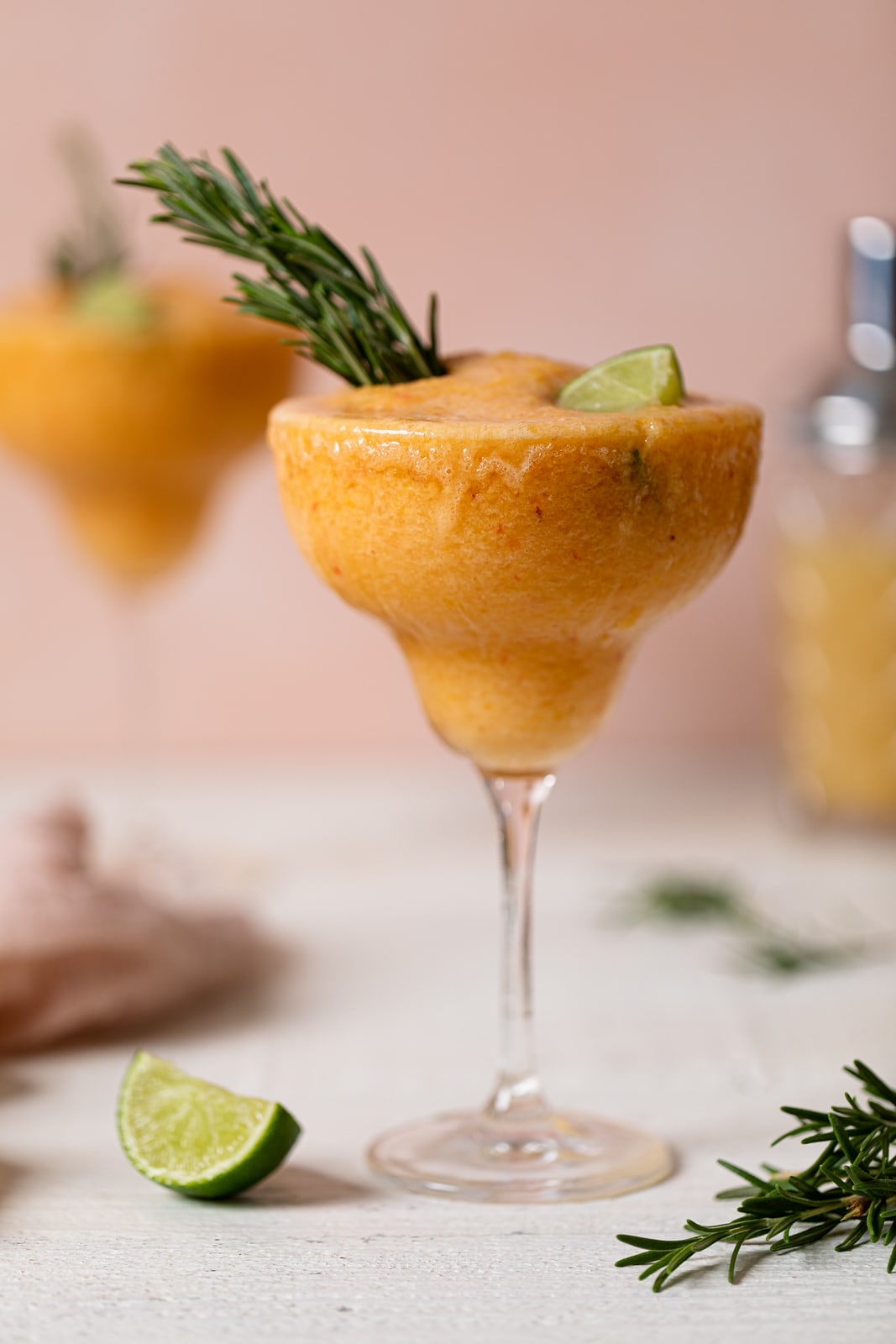 Long-stemmed glass of Frozen Peach Lime Margarita Mocktail