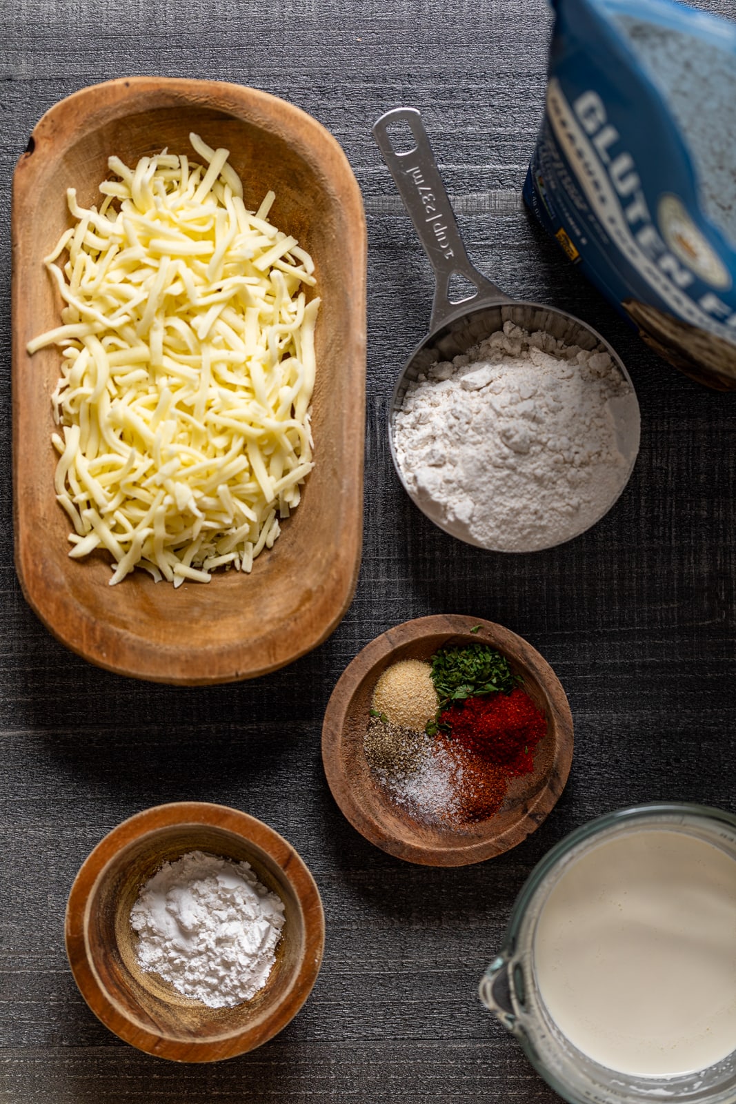 Ingredients for Gluten-Free Cheddar Bay Biscuits including shredded cheese, gluten free flour, and seasonings