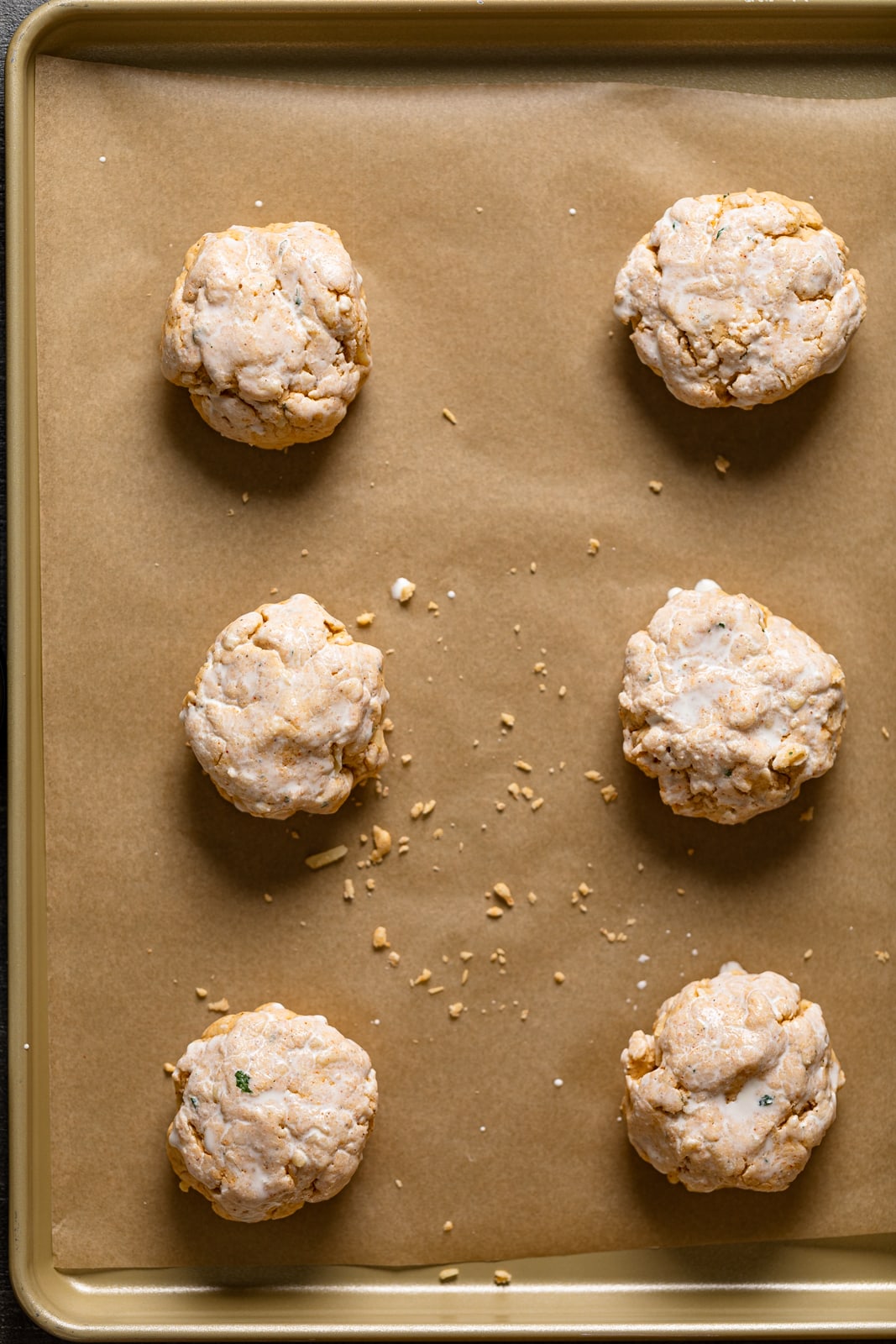 Balls of Gluten-Free Cheddar Bay Biscuit dough on parchment paper