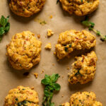Gluten-Free Cheddar Bay Biscuits on parchment paper with herbs