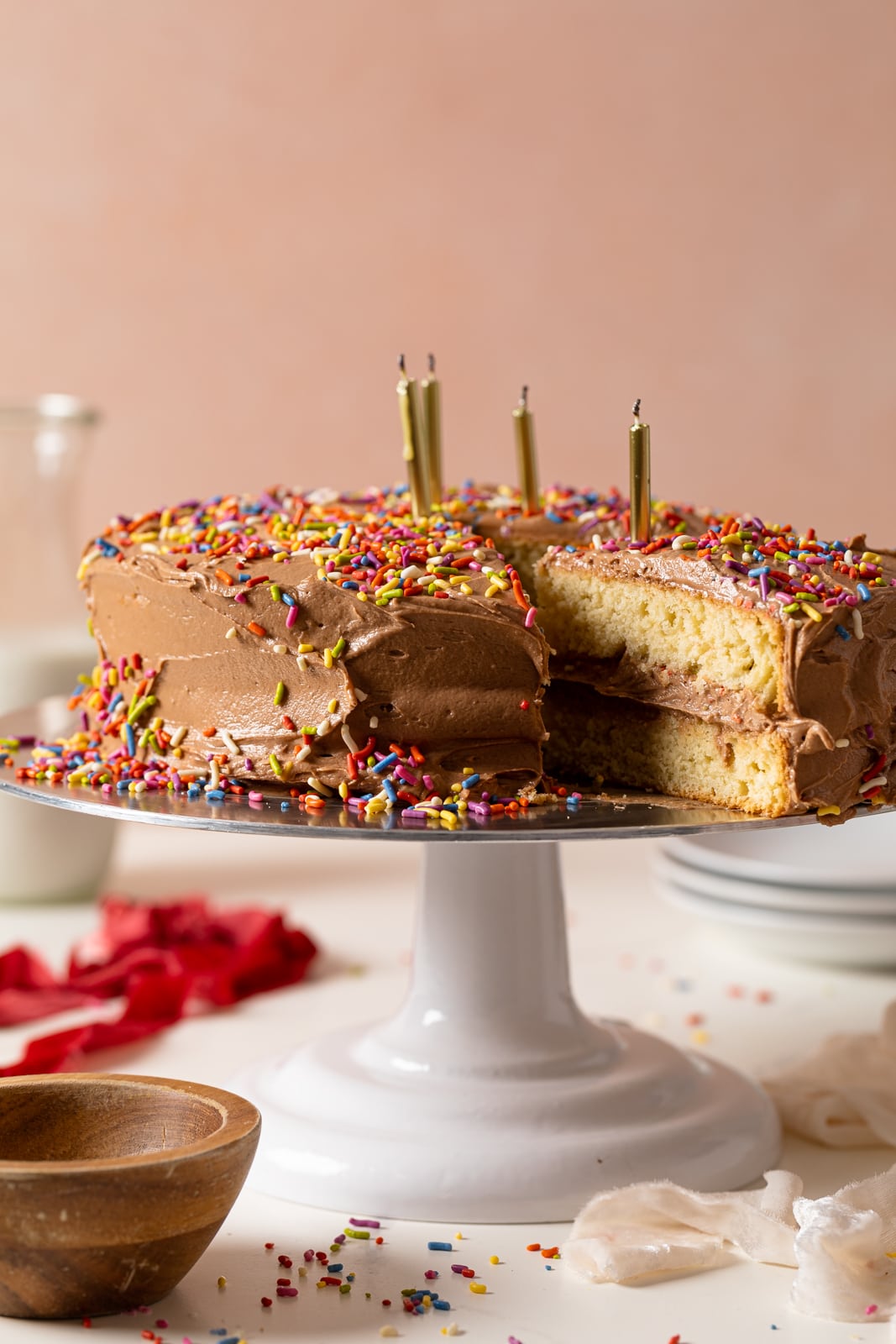  Vanilla Birthday Cake with Chocolate Frosting with a slice pulled out