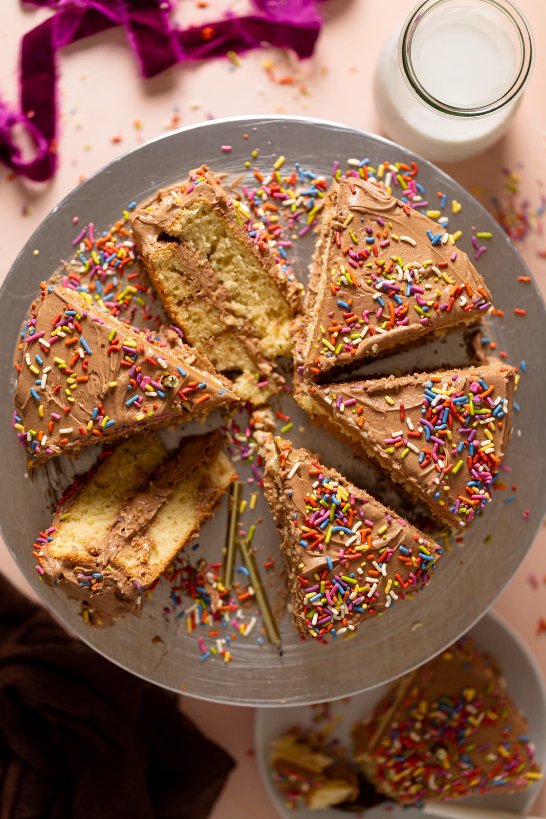 Overhead shot of a sliced Vanilla Birthday Cake with Chocolate Frosting