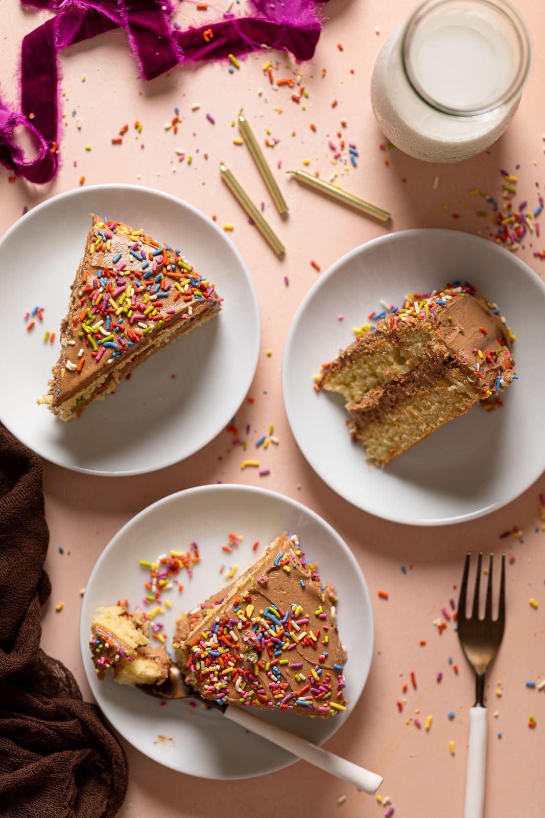 Plates with slices of Vanilla Birthday Cake with Chocolate Frosting