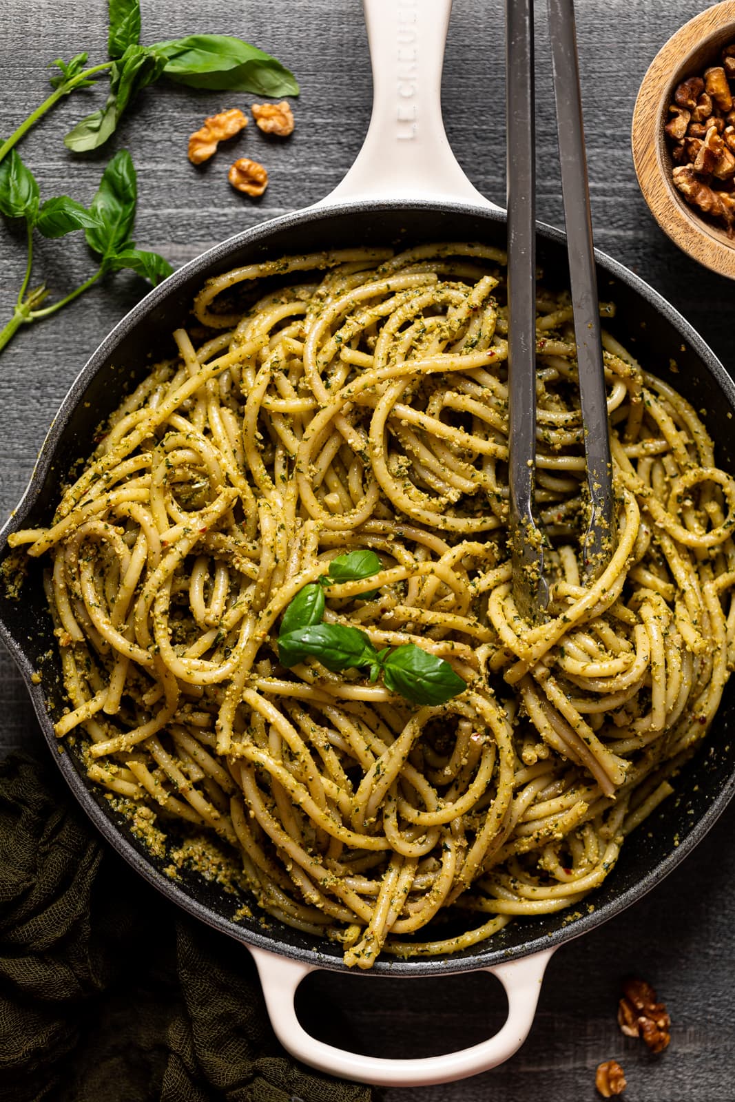 Tongs grabbing Walnut Pesto Bucatini Pasta