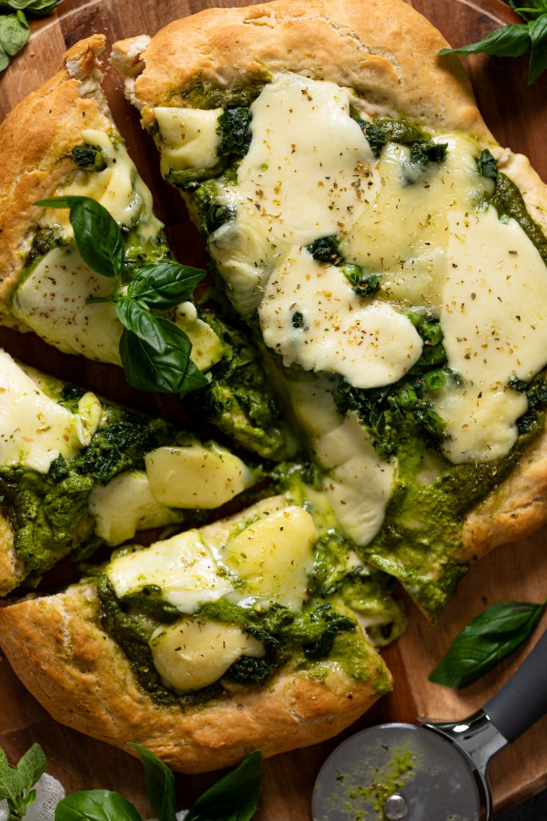 Closeup of a half-sliced Kale Pesto Pizza