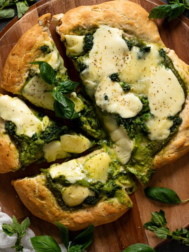 Overhead shot of a half-sliced Kale Pesto Pizza