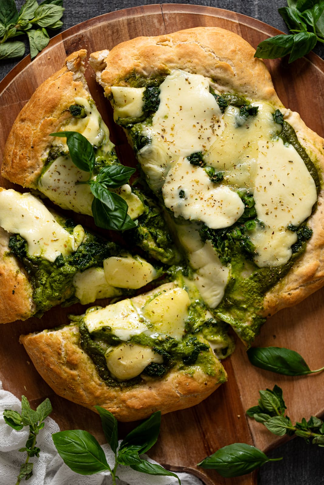 Overhead shot of a half-sliced Kale Pesto Pizza