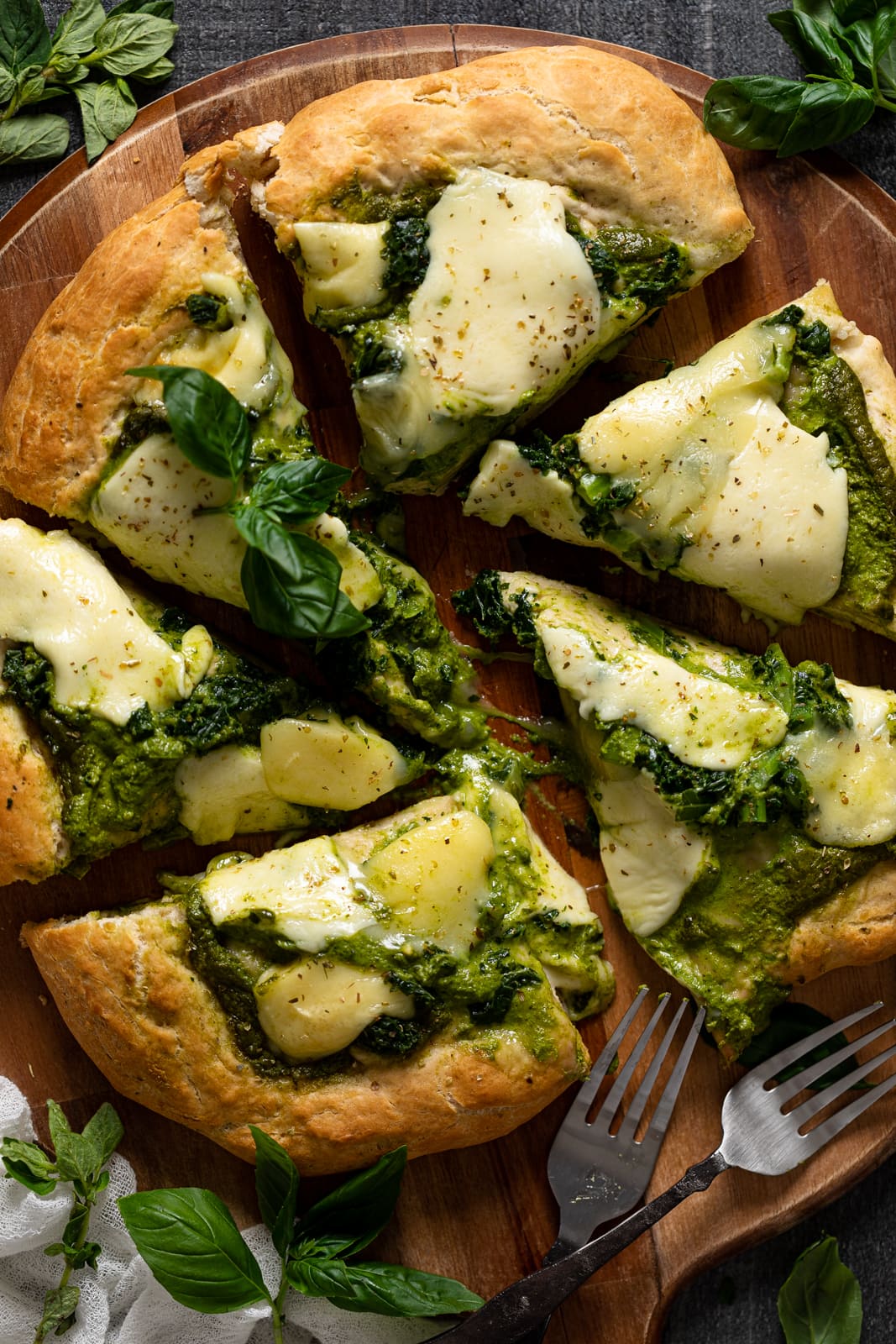 Overhead shot of a sliced Kale Pesto Pizza