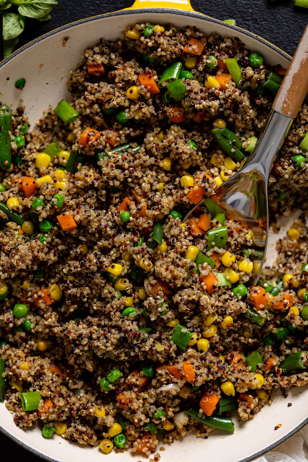 Closeup of a spoon scooping some Vegan Quinoa Fried Rice