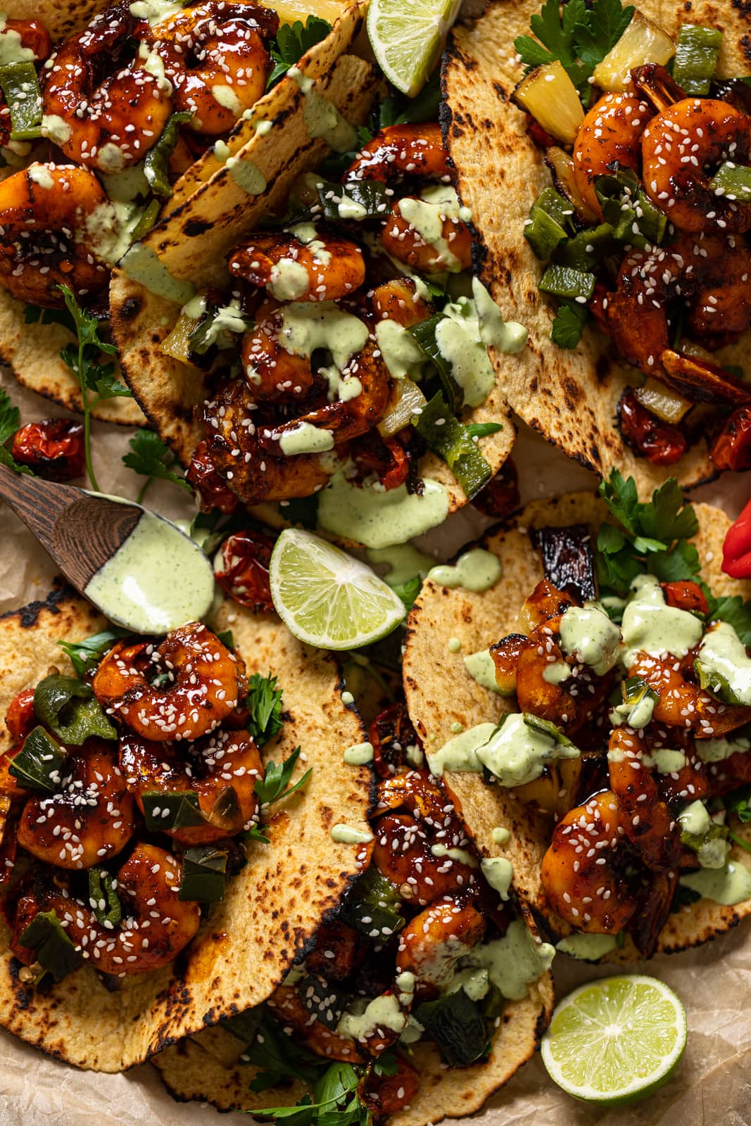 Closeup of Gochujang Shrimp Tacos drizzled with cilantro lime sauce