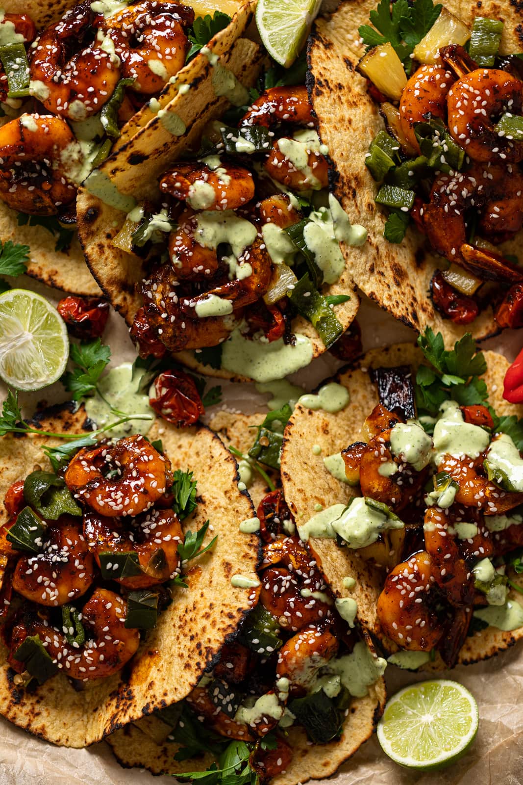 Closeup of Gochujang Shrimp Tacos drizzled with cilantro lime sauce