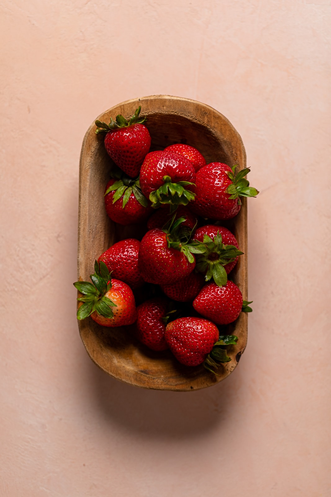Wooden bowl of strawberries
