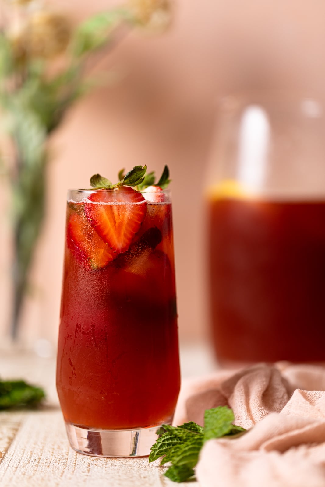 Glass of Southern Strawberry Iced Sweet Tea topped with strawberry halves