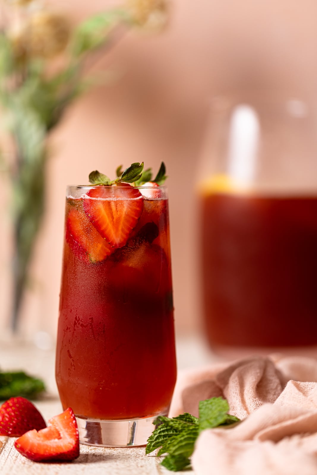 Glass of Southern Strawberry Iced Sweet Tea topped with strawberry halves