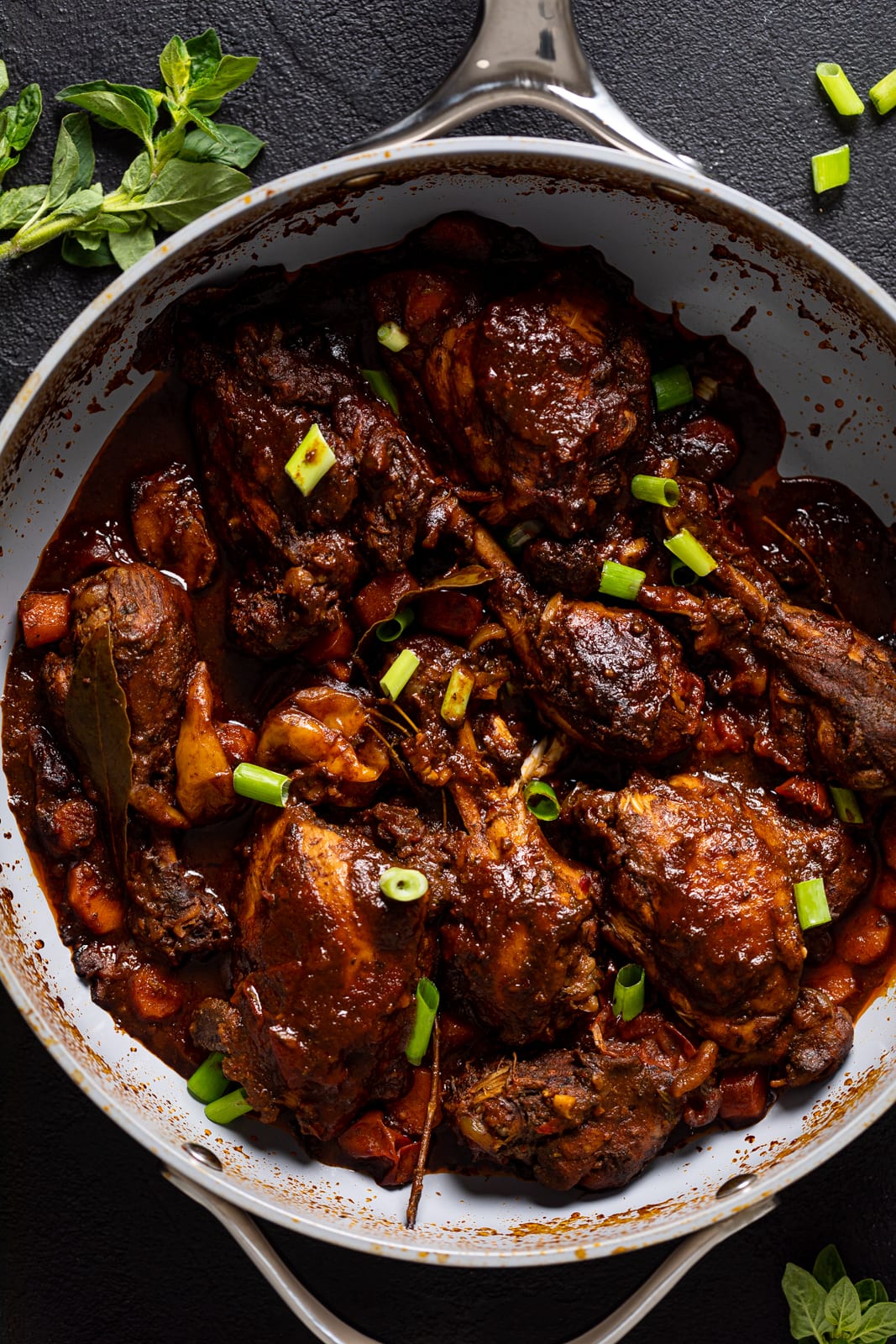 Overhead shot of a pan of Jamaican Brown Stew Chicken