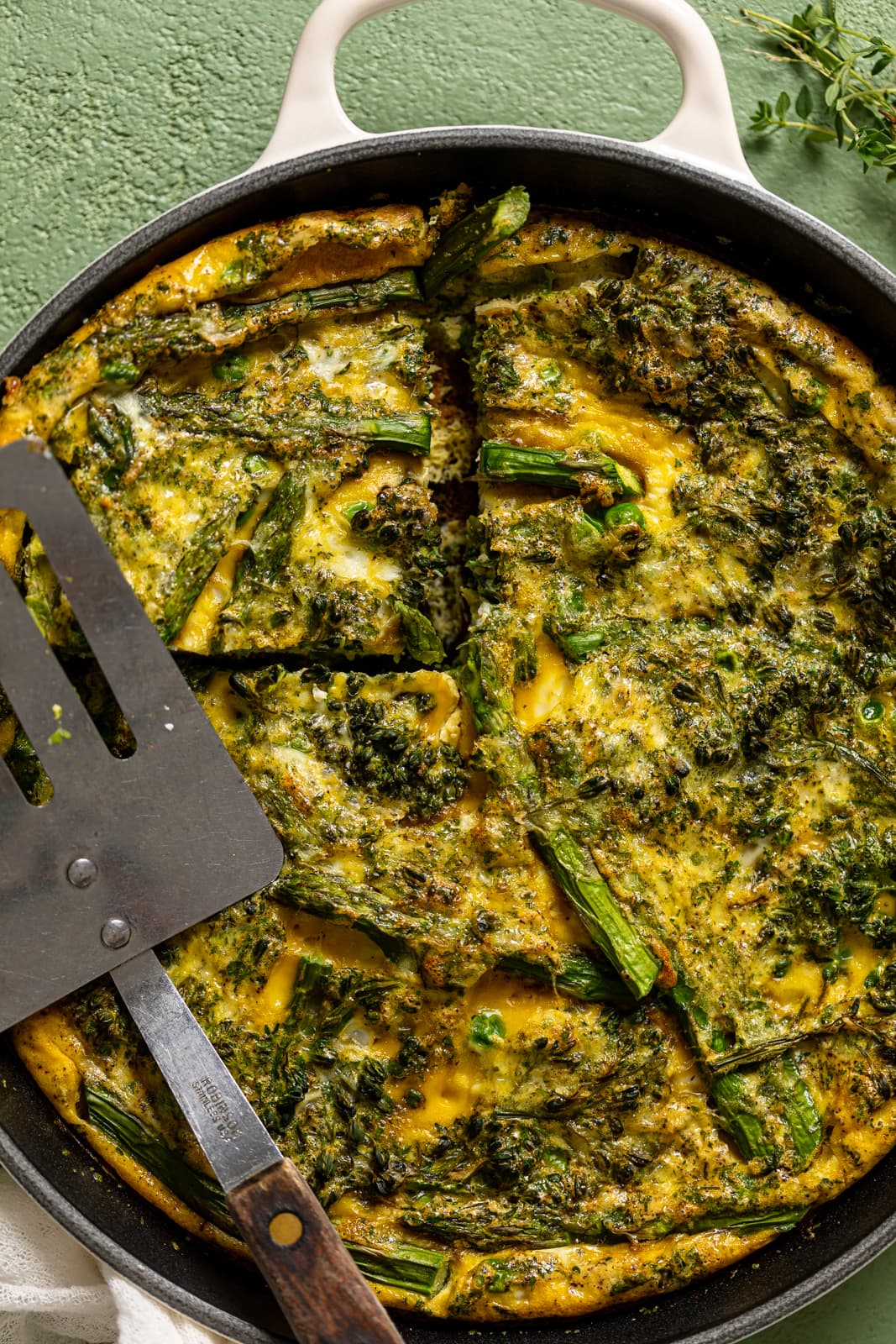 Closeup of a metal spatula on a Spring Vegetable Frittata