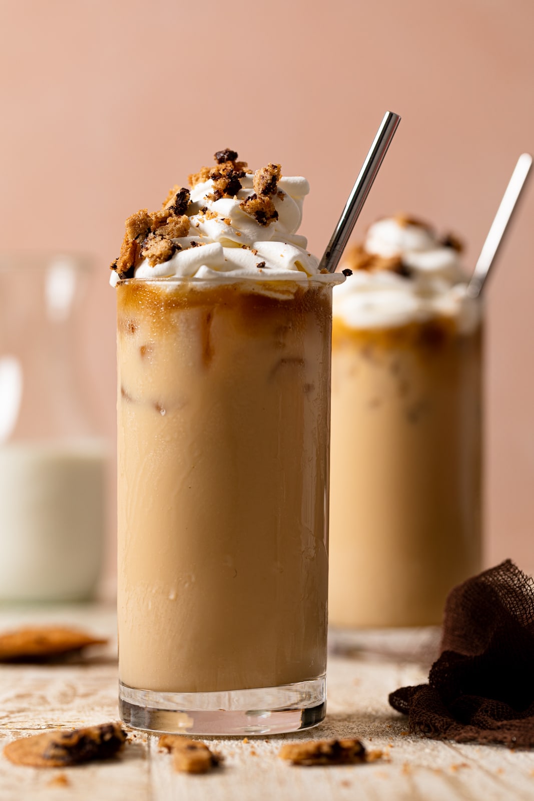 Two Brown Butter Maple Cookie Lattes with straws in glasses