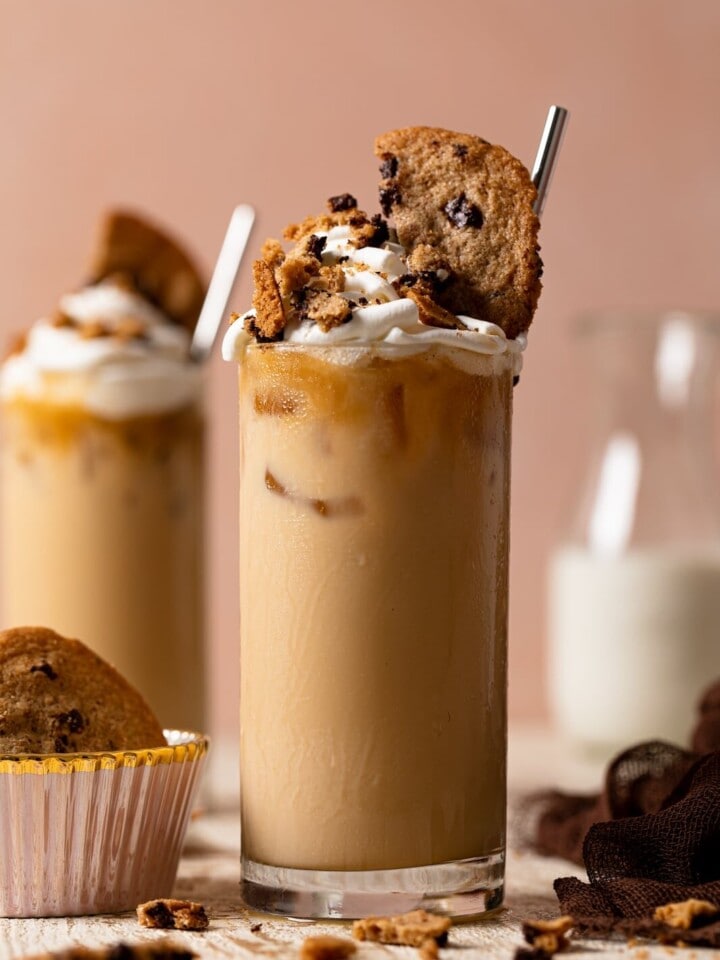 Brown Butter Maple Cookie Latte in a glass topped with whipped cream and cookies