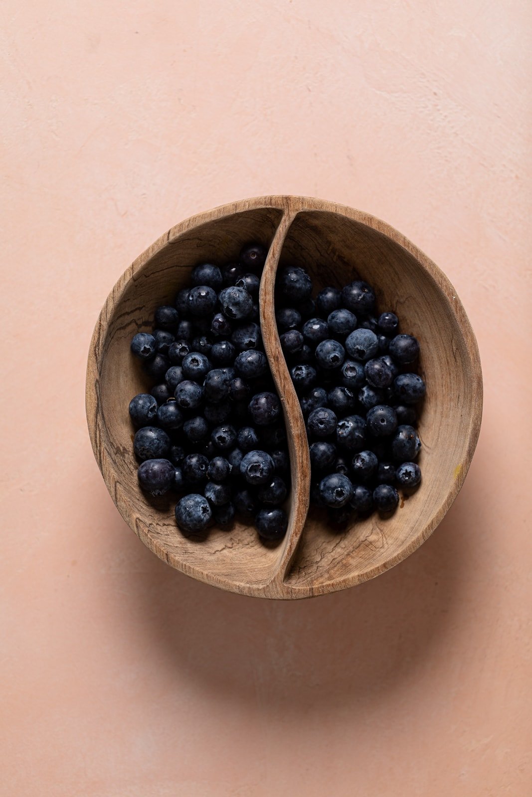 Wooden bowl of blueberries