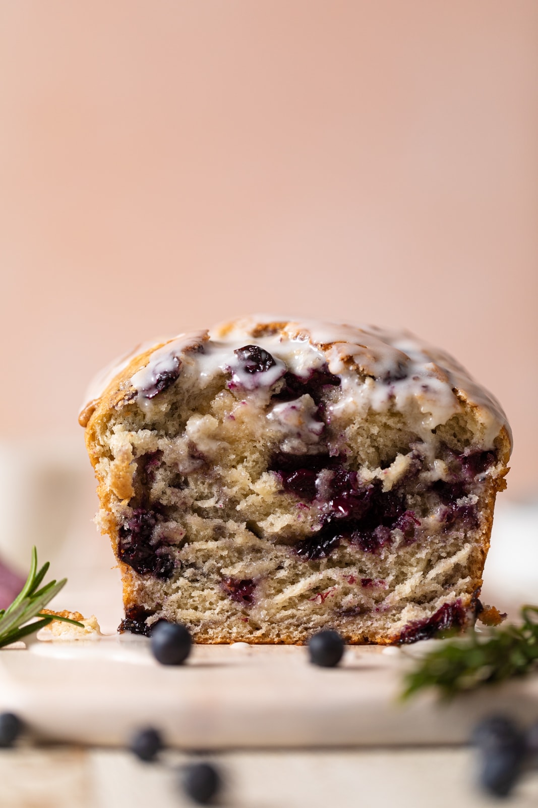 Loaf of Roasted Blueberry Lemon Olive Oil Bread with the end sliced off on a plate