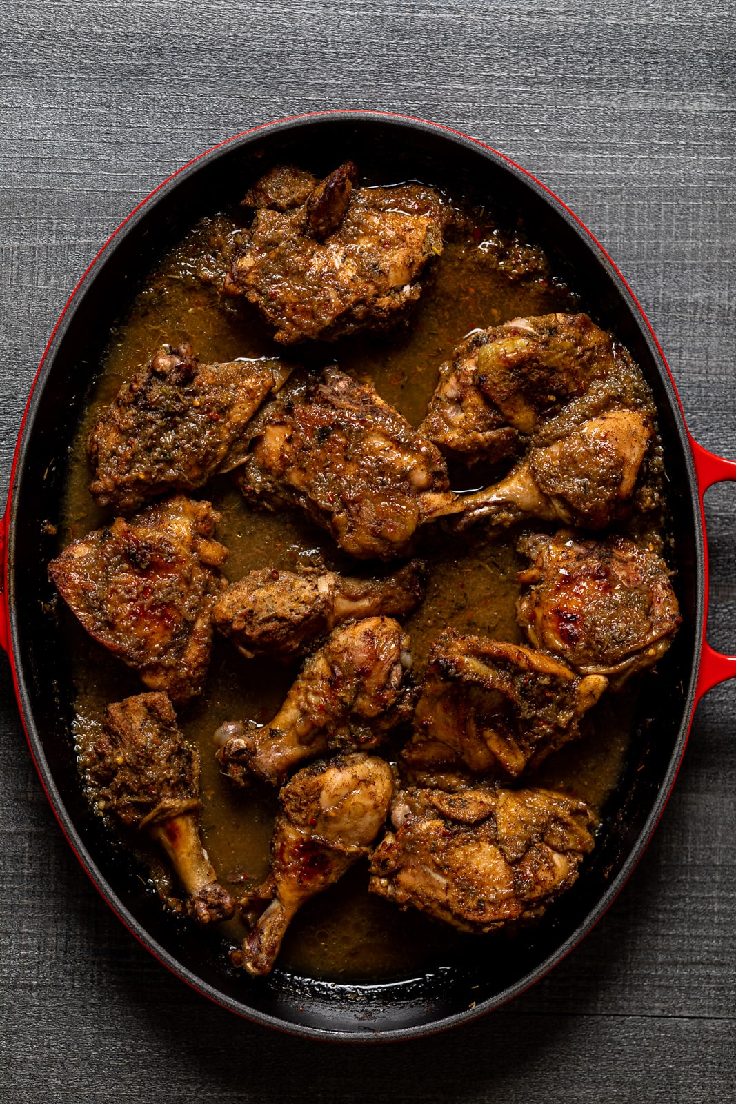 Overhead shot of a Dutch oven of Baked Jamaican Pineapple Jerk Chicken