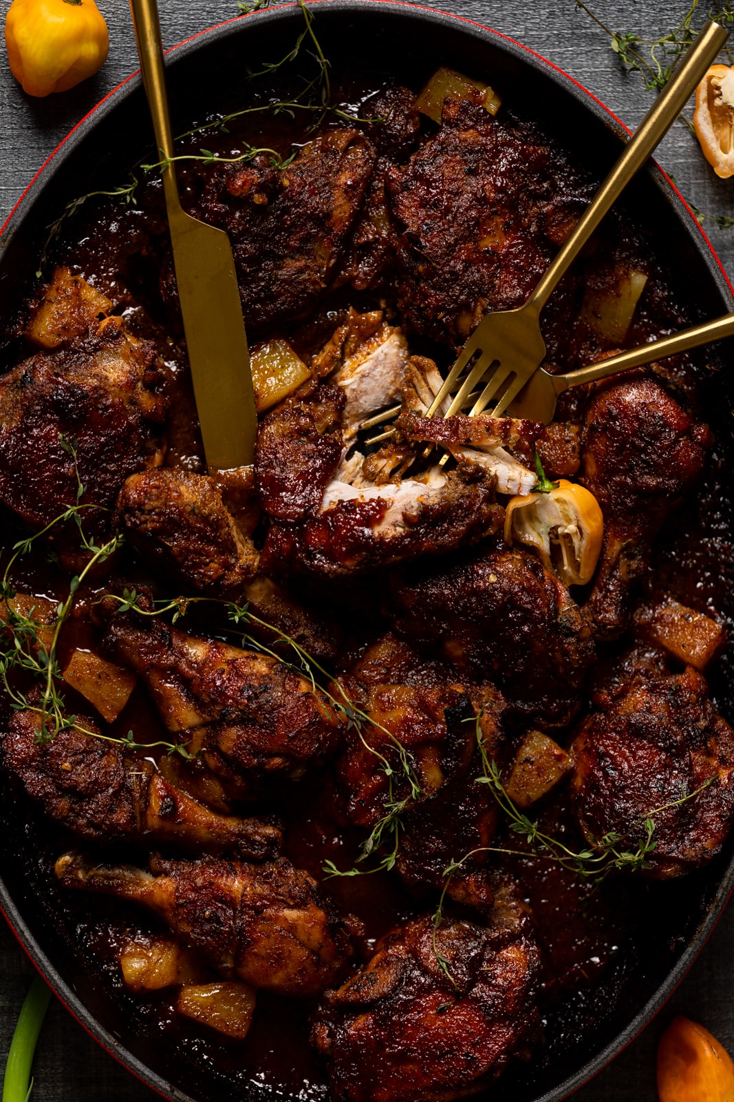 Baked Jamaican Pineapple Jerk Chicken being split apart with two forks