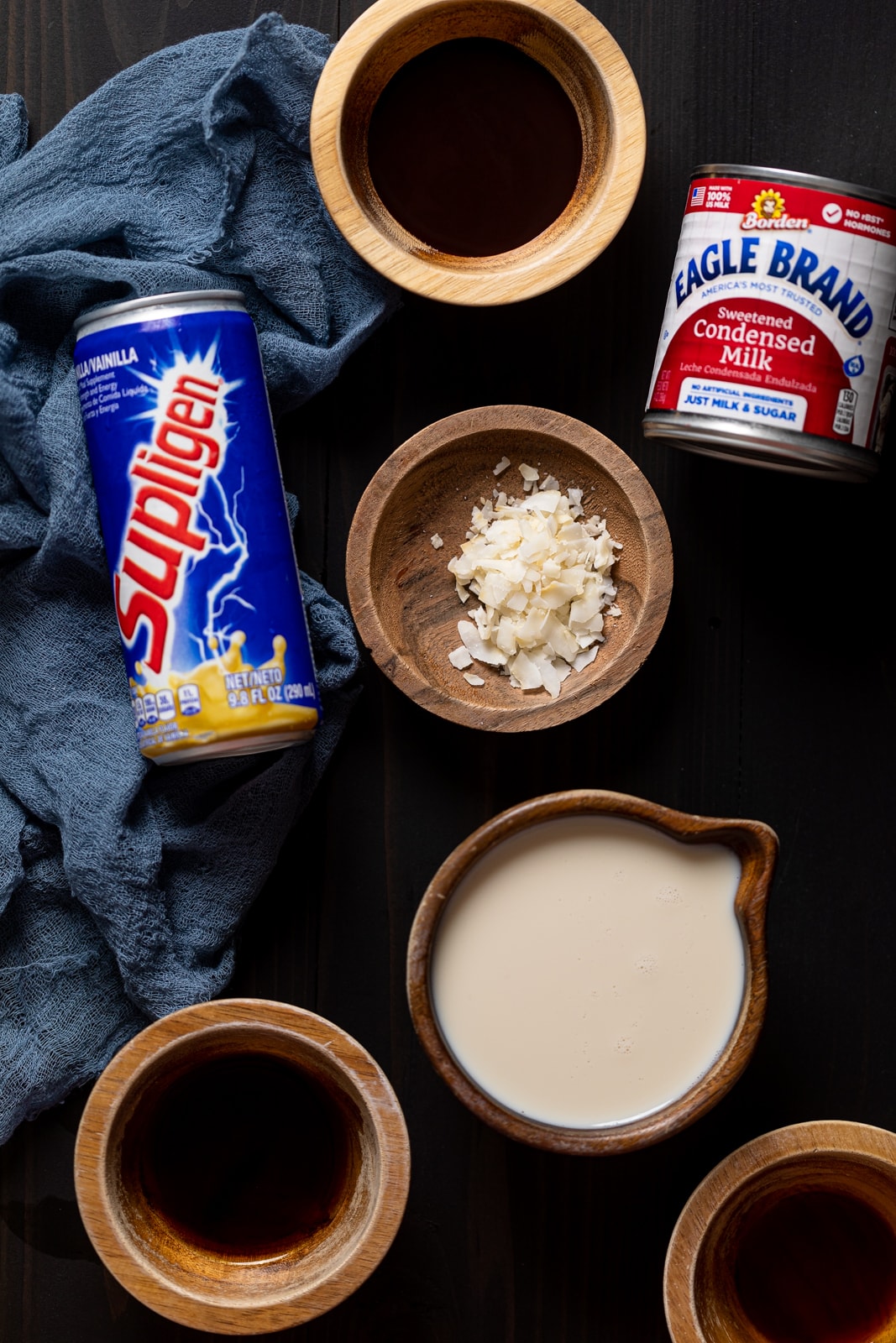 Ingredients for alcohol-free Jamaican Rum Cream including sweetened condensed milk, vanilla Supligen, and plant-based milk