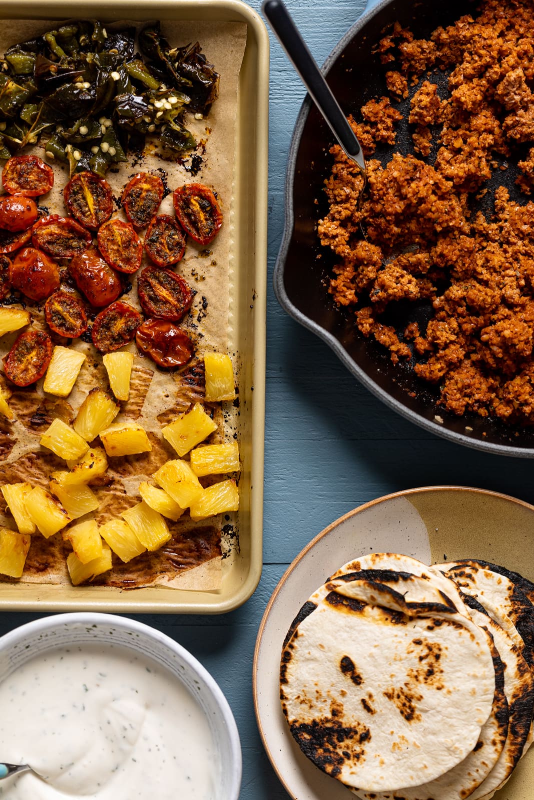 Ingredients for Vegan Jamaican Jerk Walnut Tacos including roasted produce, tortillas, and walnut taco \"meat\"