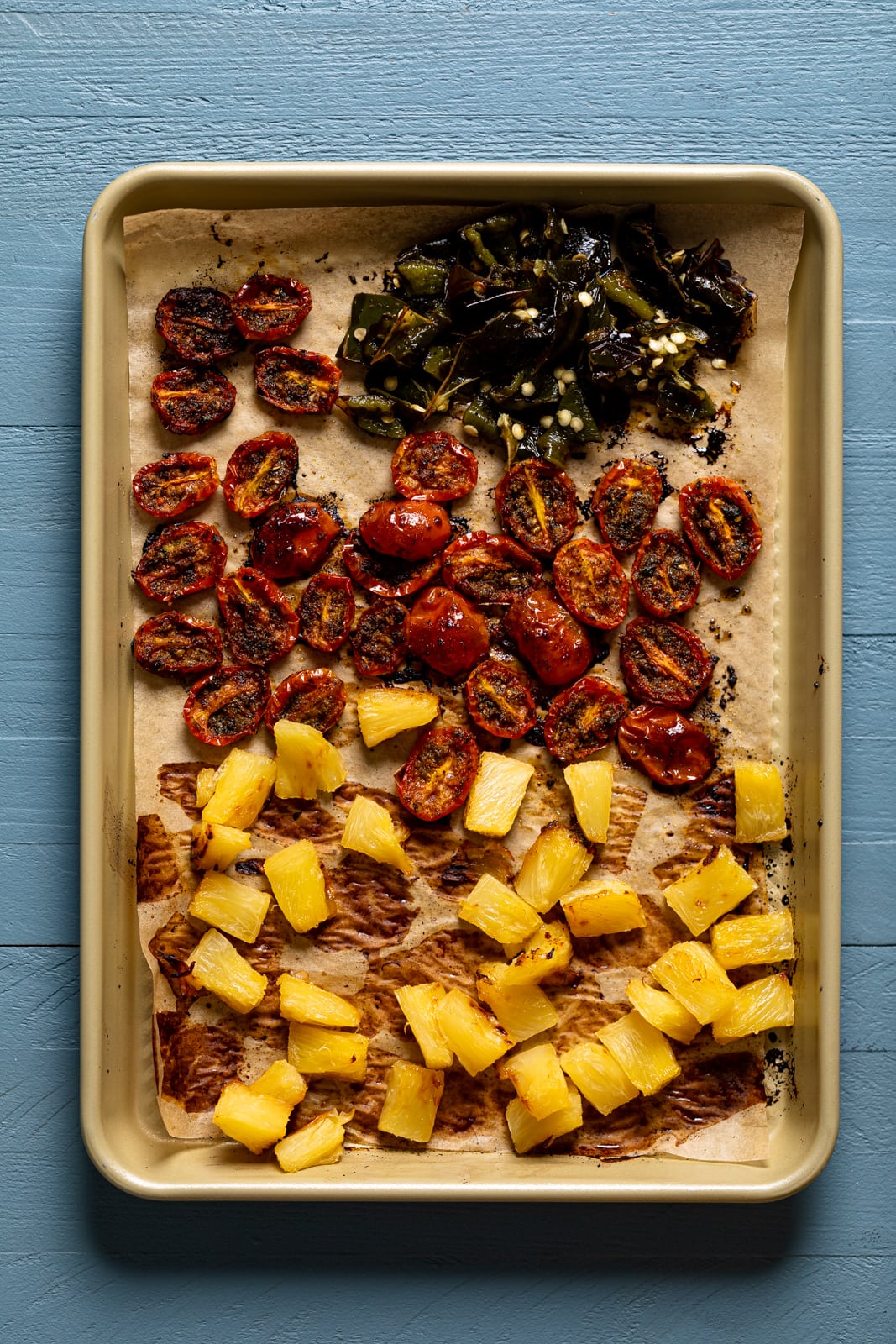 Sheet pan of toasted tomatoes, pineapples, and peppers