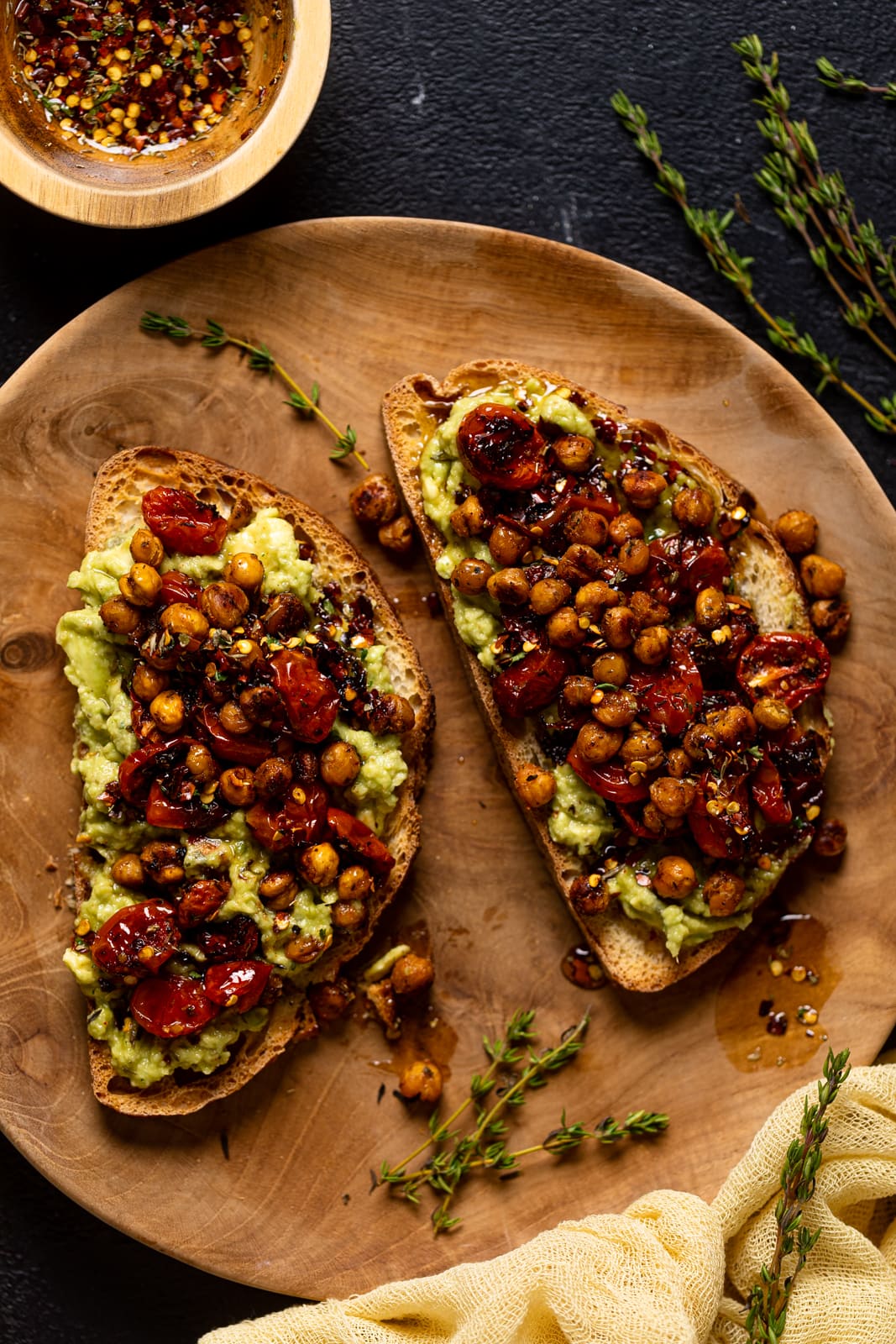 Closeup of a plate with two pieces bread with toppings. 