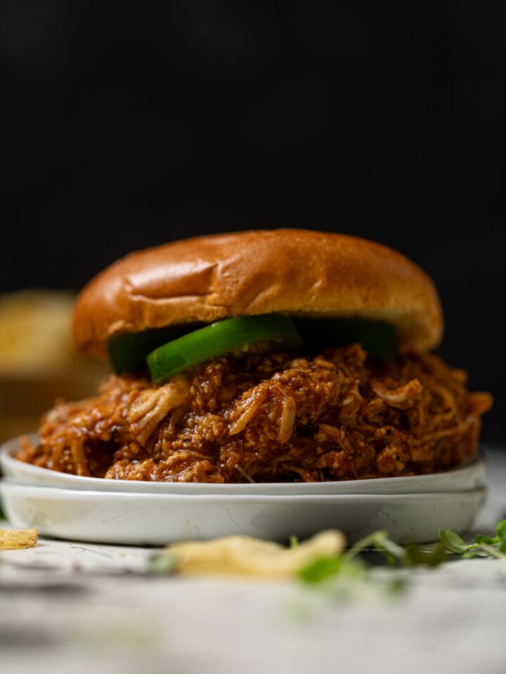 Best BBQ Pulled Chicken Sandwich on a white plate.