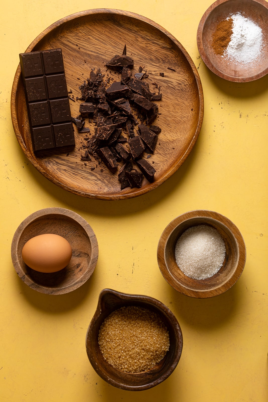 Ingredients for Big Brown Butter Chocolate Chip Cookies including chocolate, egg, and sugar
