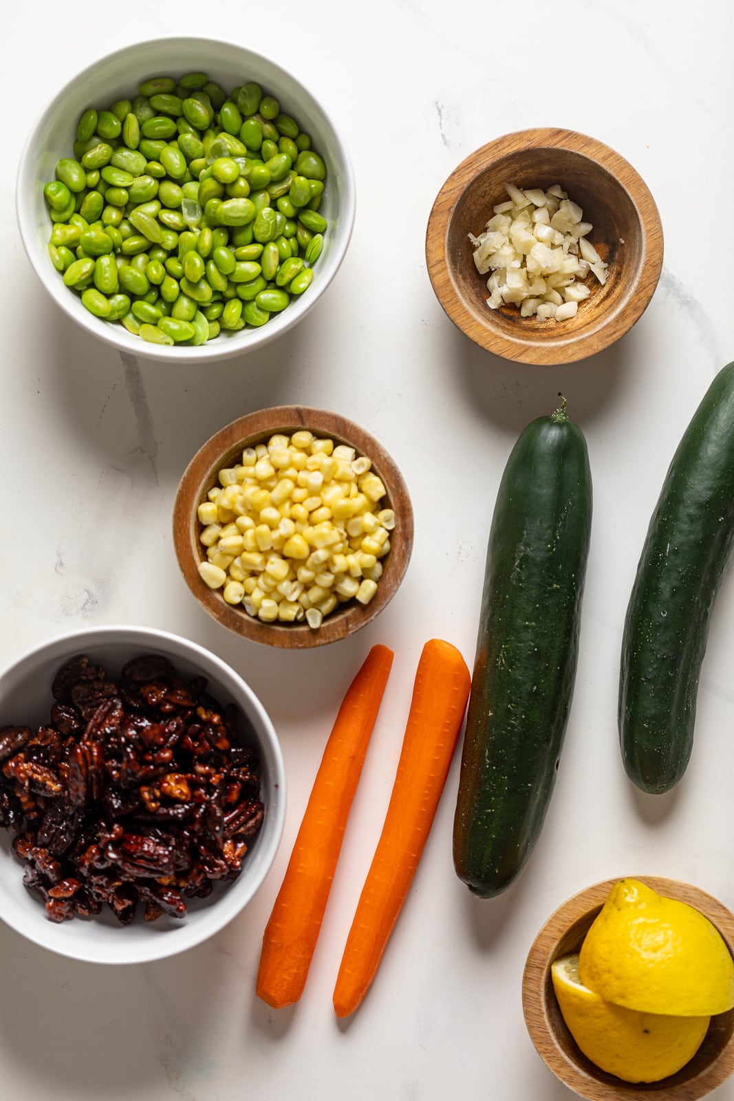 Ingredients for Summer barbeque Chopped Kale Salad including cucumbers, carrots, and corn