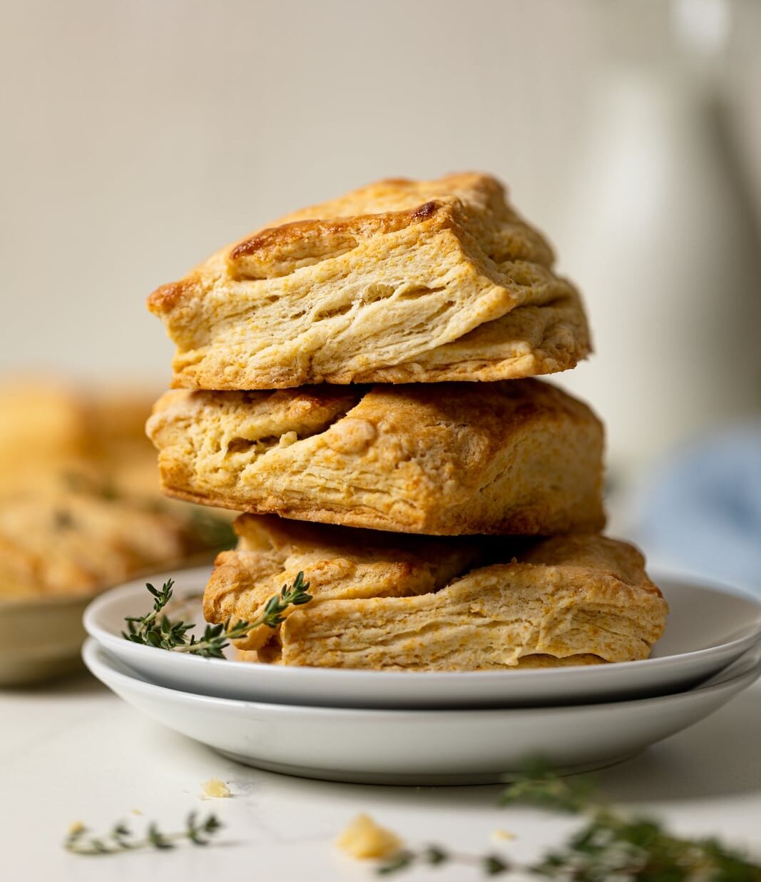 Pile of Flaky Honey Buttermilk Biscuits on two plates