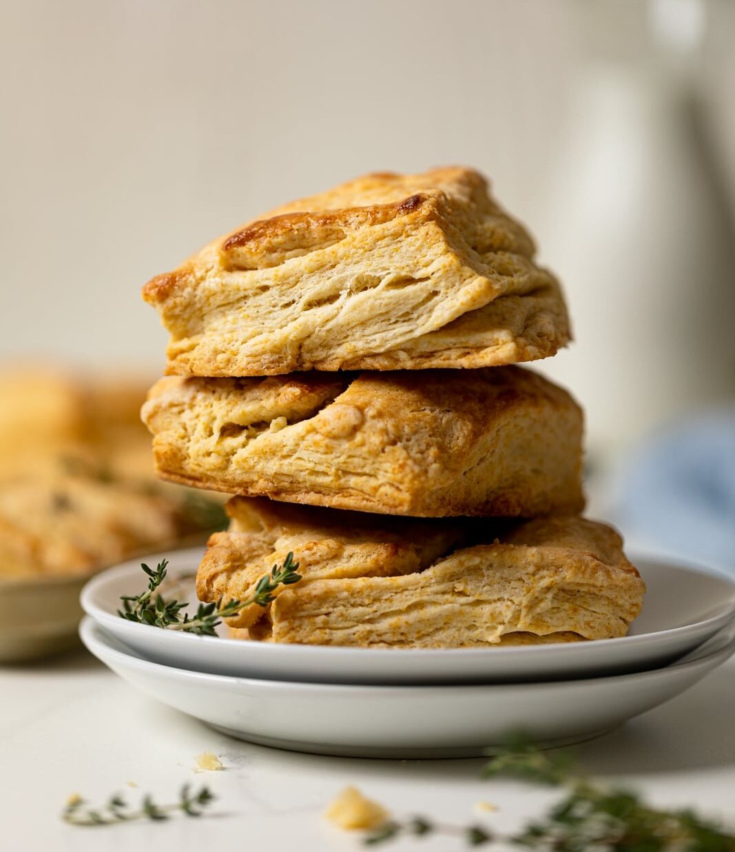 Pile of Flaky Honey Buttermilk Biscuits on two plates. 