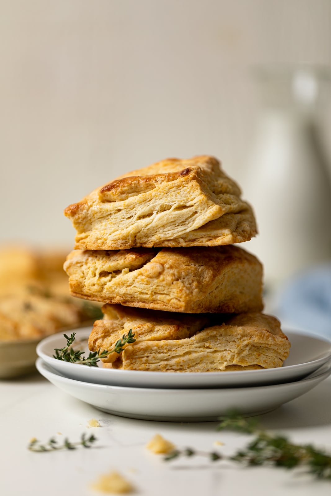 Pile of Flaky Honey Buttermilk Biscuits on two plates