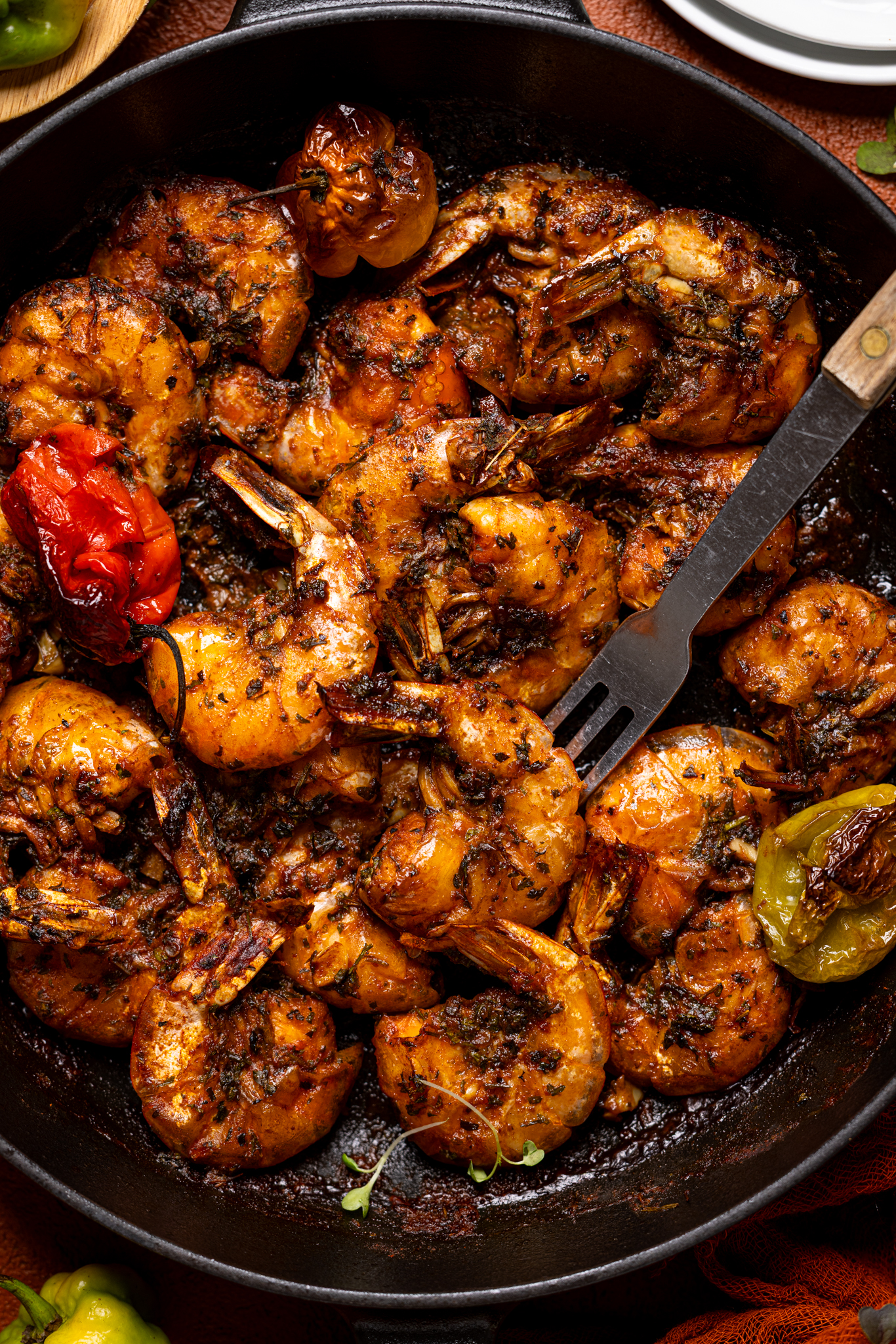 Up close shot of Jamaican Pepper Shrimp in a skillet with a fork.