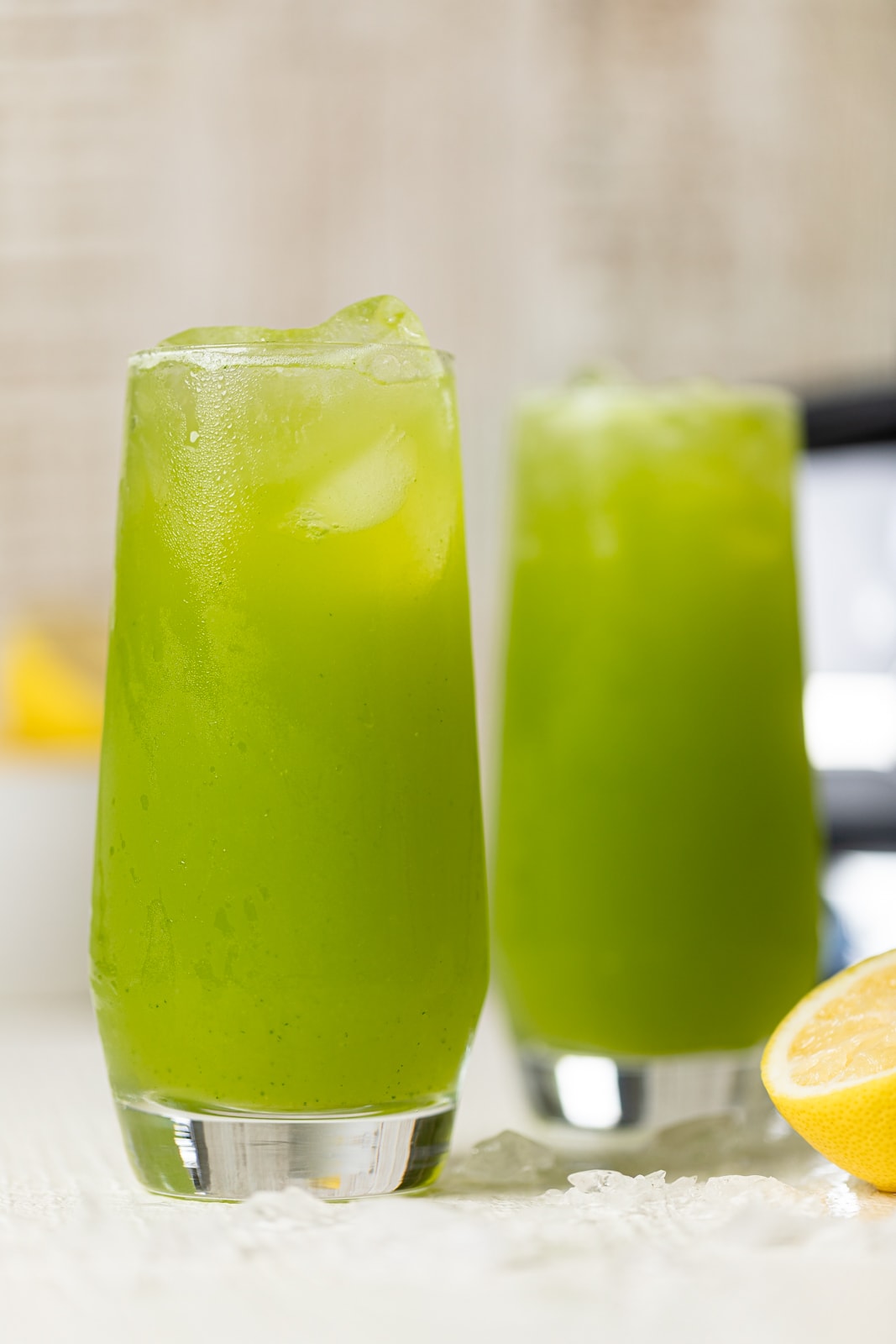 Closeup of two glasses of bright green Kale Lemonade