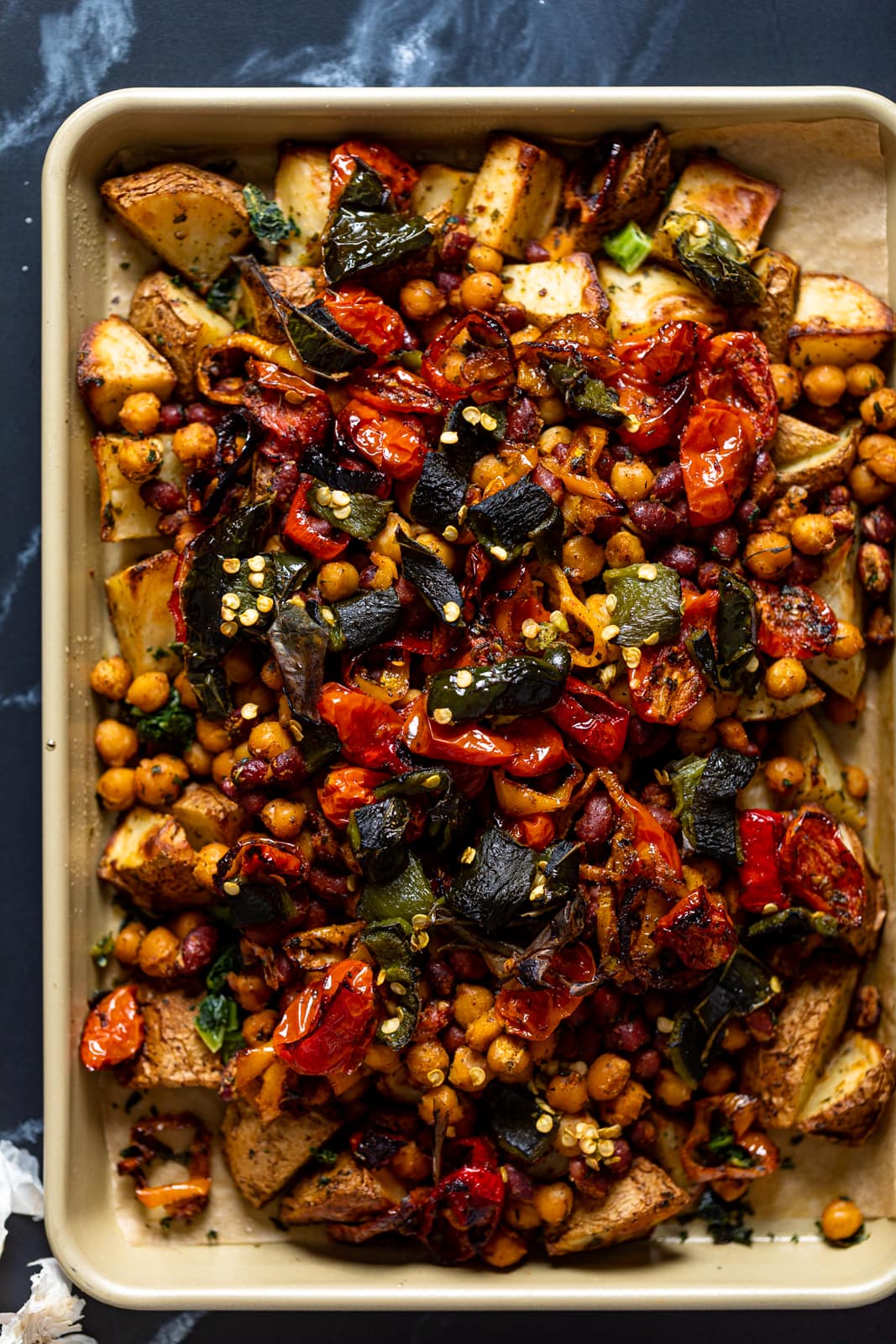 Overhead shot of a sheet pan of Loaded Potatoes with Spicy Beans