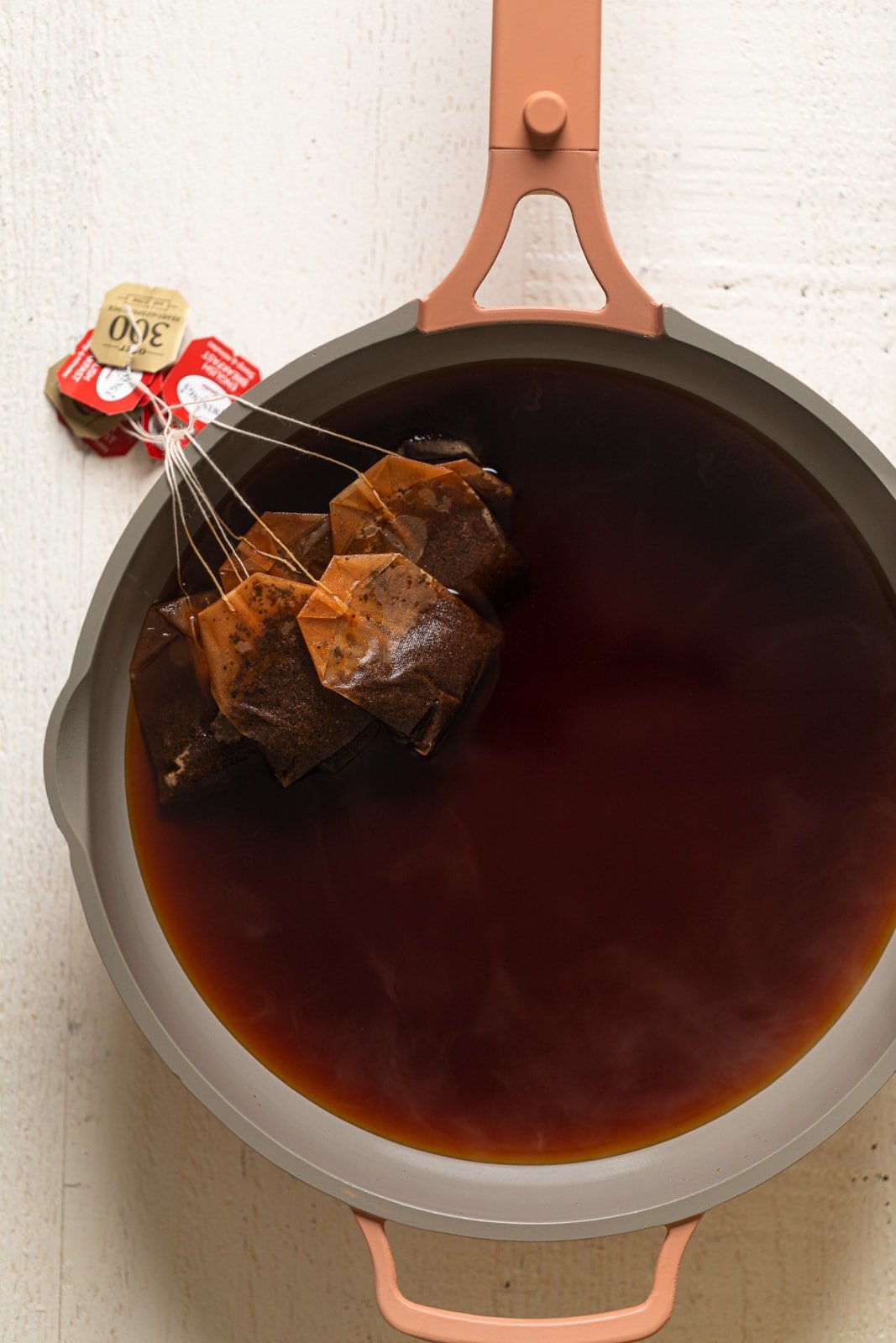 Tea bags steeping in a pot of water
